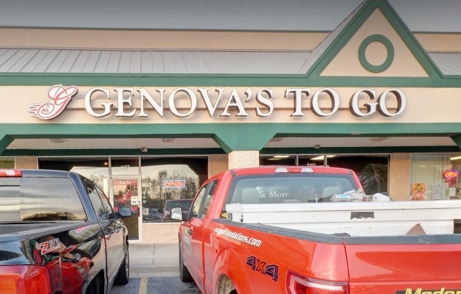 Two trucks parked in front of Genova's To Go Hampstead location with a sign that says 'Genova to Go'.