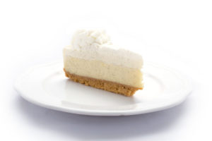 Treat yourself to the scrumptious goodness of Genova's To Go cheesecake, resting temptingly on a white plate.