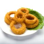 Fried onion rings with lettuce on top, served at Genova's To Go. A delicious and crispy appetizer!