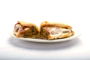 Treat yourself to a delectable eggplant parm sub from Genova's To Go, served on a plate.