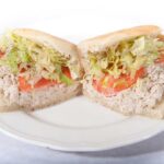 A delicious tuna salad sub from Genova's To Go, served on a plate.