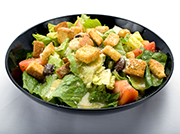 A delicious Caesar salad with croutons and tomatoes. The perfect meal from Genova's To Go.