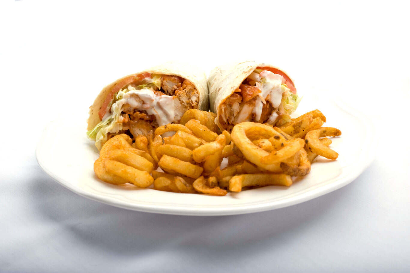 A mouthwatering buffalo chicken wrap accompanied by golden fries on a plate from Genova's To Go.