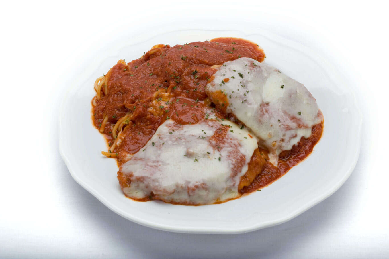 Plate of Chicken Parm meatballs and sauce on white surface. Delicious Italian dish from Genova's To Go.