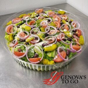 A large catering salad bowl made by Genova's To Go including fresh onions, tomatoes, peppers, parmesan cheese, etc.
