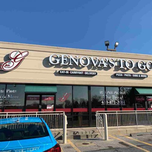 Genova's To Go restaurant in Westminster, MD with a car parked in front.